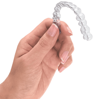 Hand Holding Clear Aligner